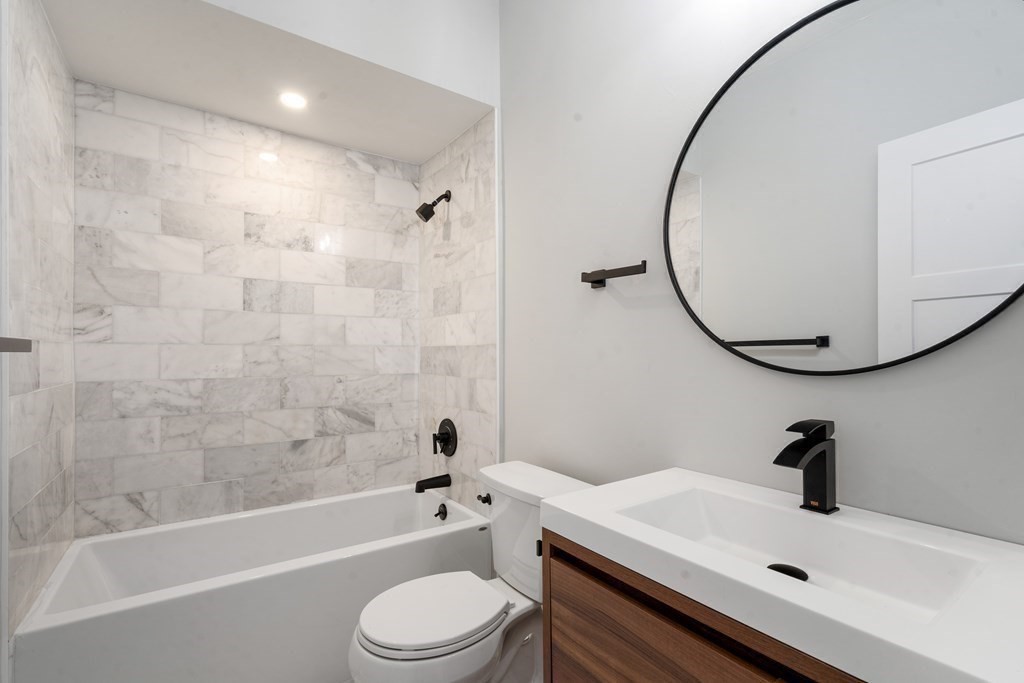 31 Monadnock Street, Unit 2 Boston, MA 02125 - Photo 8 of 11 a bathroom with a sink a toilet and a mirror