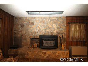 940 Hidden Valley Road Clyde, NC 28721 - Photo 17 of 23 a living room with a fireplace