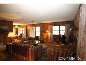 940 Hidden Valley Road Clyde, NC 28721 - Photo 4 of 23 a living room with furniture a large window and potted plant