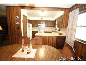 940 Hidden Valley Road Clyde, NC 28721 - Photo 9 of 23 a kitchen with a wooden floor and a large window