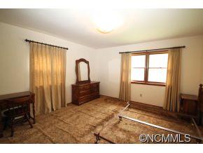 940 Hidden Valley Road Clyde, NC 28721 - Photo 10 of 23 a view of a room with a window and a kitchen