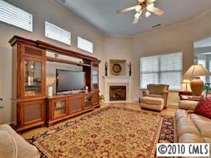 135 Whitley Mills Road Fort Mill, SC 29708 - Photo 3 of 8 a living room with furniture a flat screen tv and a fireplace