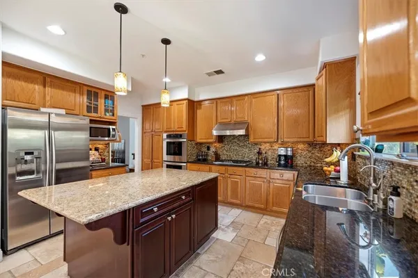 a kitchen with a stove sink and cabinets