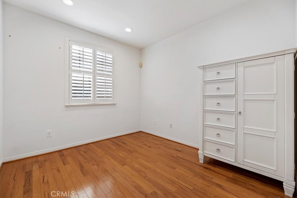 2310 Crown Point Court Oxnard, CA 93036 - Photo 19 of 50 a view of an empty room with a window and wooden floor