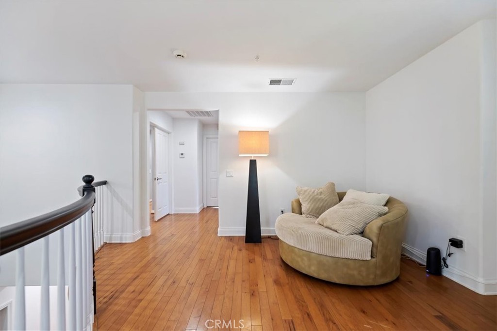 2310 Crown Point Court Oxnard, CA 93036 - Photo 24 of 50 a living room with furniture and wooden floor