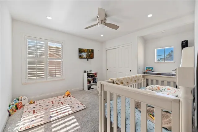 a bedroom with a bed couch and a window