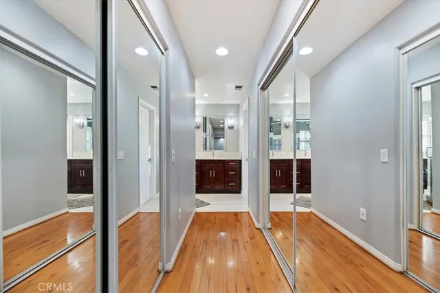 a spacious bathroom with a double vanity sink a mirror and a shower