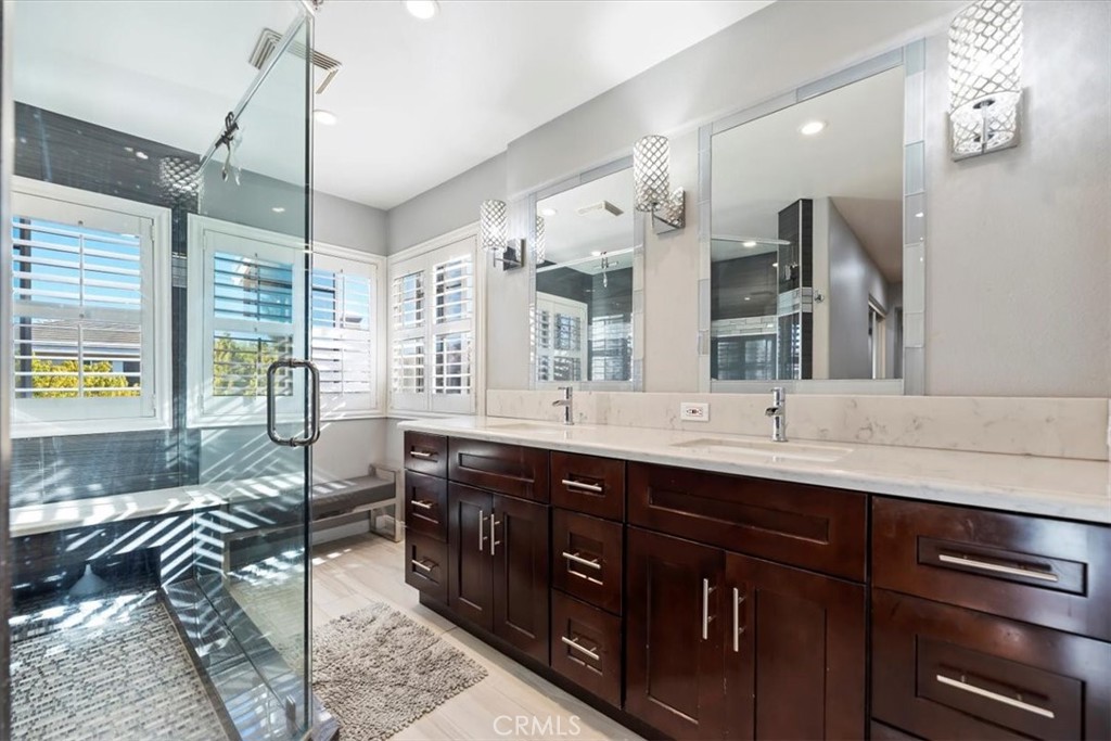 2310 Crown Point Court Oxnard, CA 93036 - Photo 32 of 50 a spacious bathroom with a double vanity sink a mirror and a shower