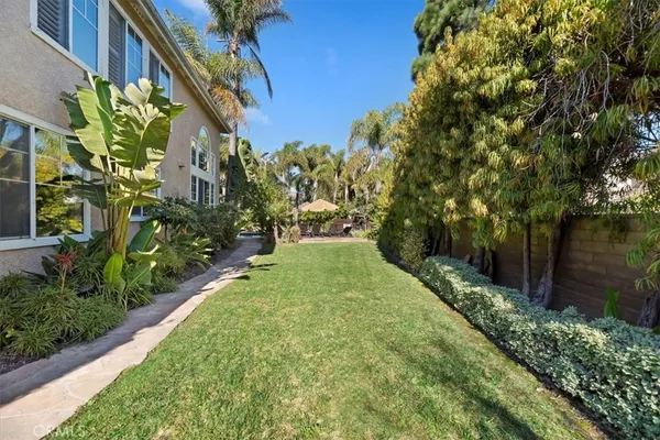 a view of backyard with outdoor seating and trees