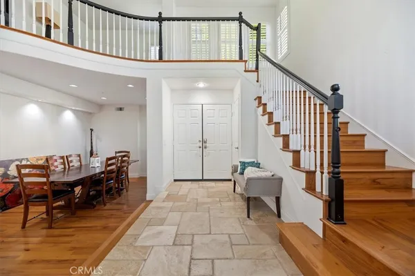 a view of entryway with wooden floor and stairs