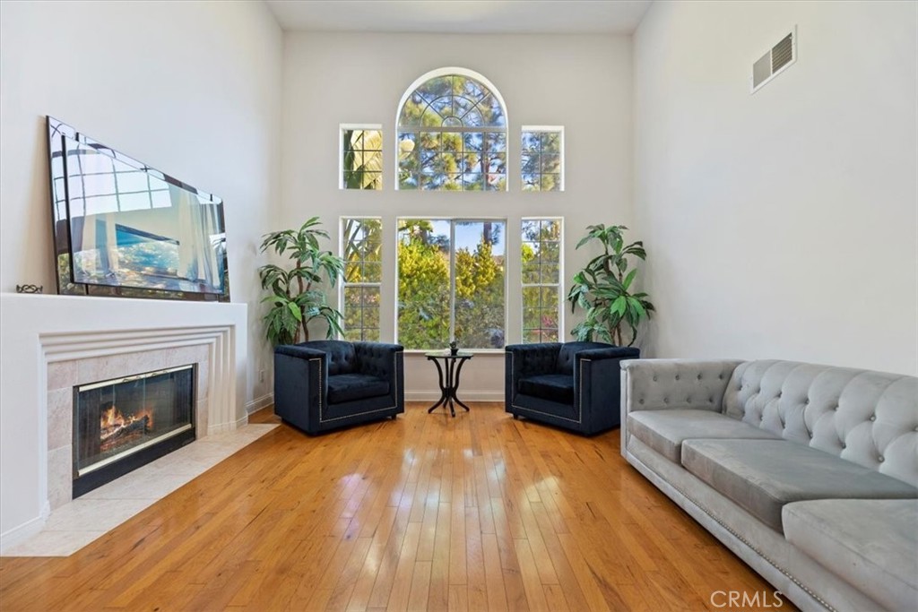 2310 Crown Point Court Oxnard, CA 93036 - Photo 8 of 50 a living room with furniture and a fireplace