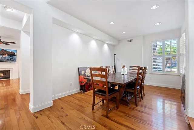 a view of a hallway with wooden floor and furniture