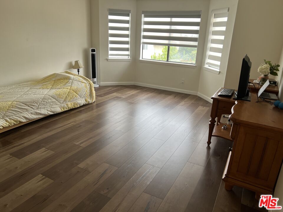 19528 Eagle Ridge Lane Porter Ranch, CA 91326 - Photo 12 of 20 a room with wooden floor and two window