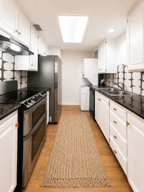 2529 Rio Grande Street, Unit 78 Austin, TX 78705 - Photo 4 of 14 A well-lit galley kitchen boasts sleek appliances and ample cabinetry.