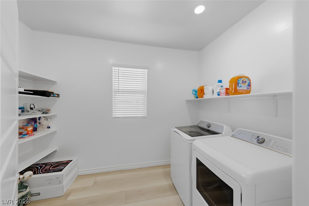 290 Rusty Ridge Lane Henderson, NV 89015 - Photo 25 of 61 Laundry room with luxury vinly plank floors, washer & dryer and plenty of storage
