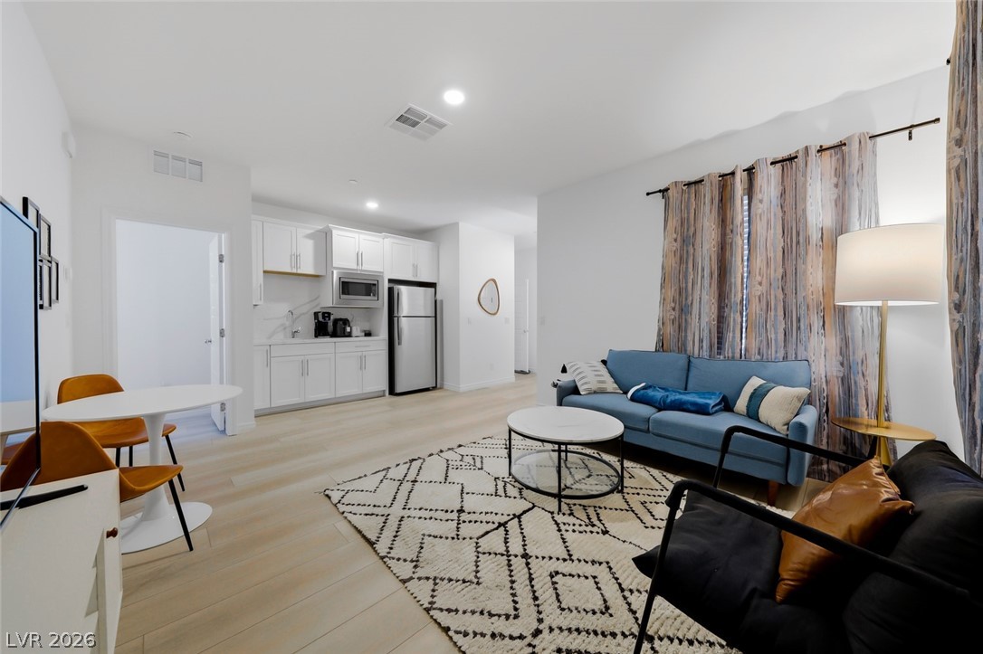 290 Rusty Ridge Lane Henderson, NV 89015 - Photo 33 of 61 First Floor Fully Furnished Next-Gen Suite w/separate entry, Kitchenette, living room, bed & bath, luxury vinly plank floors, fridge, convection microwave & Stackable washer/dryer.