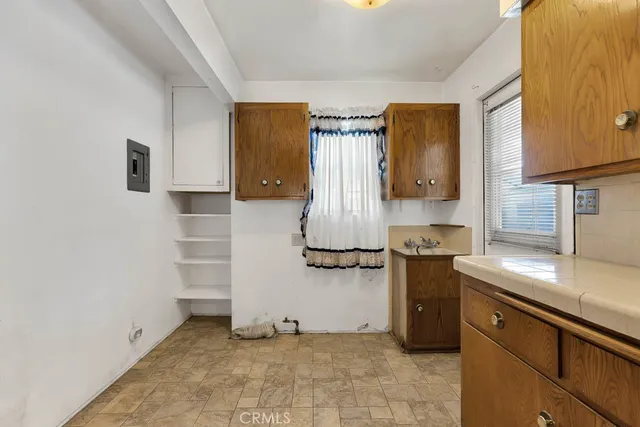 a kitchen with a refrigerator and a sink