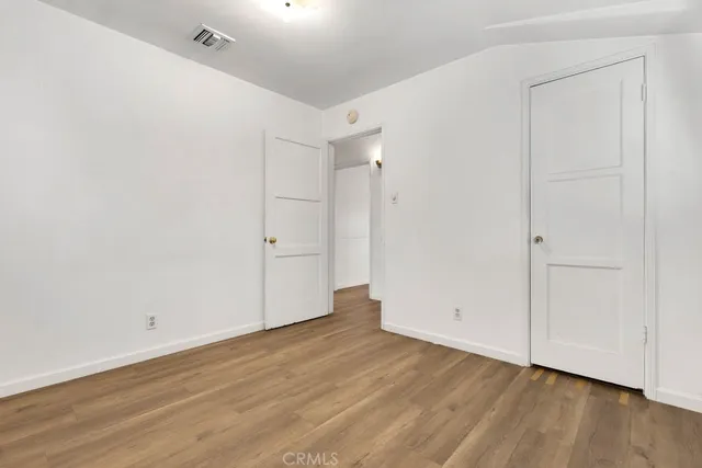 an empty room with wooden floor