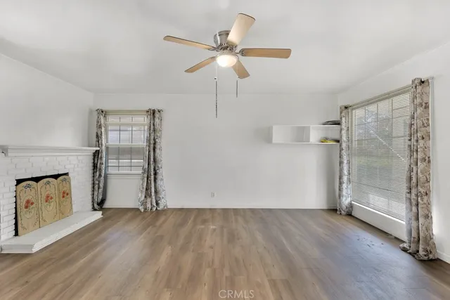 wooden floor in an empty room with a fireplace