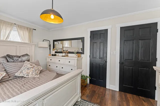 a bedroom with a bed and a dresser in it