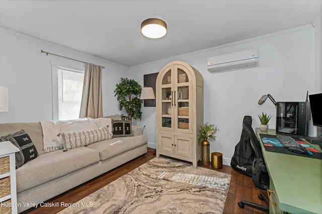 a living room with furniture and wooden floor
