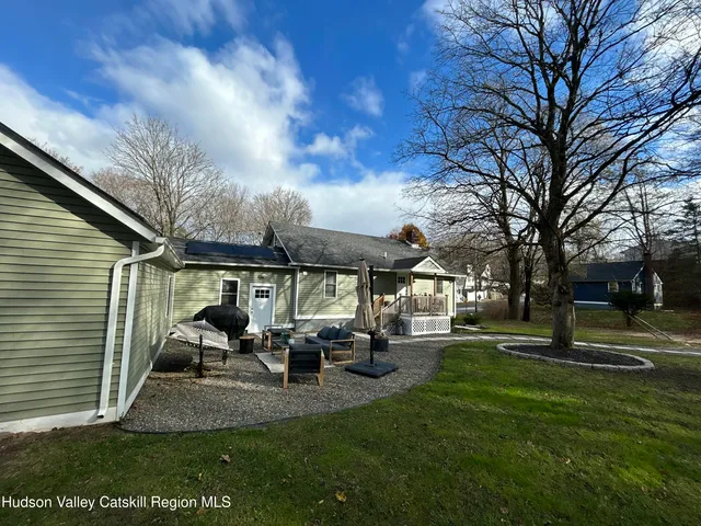 a view of a patio with table and chairs under an umbrella