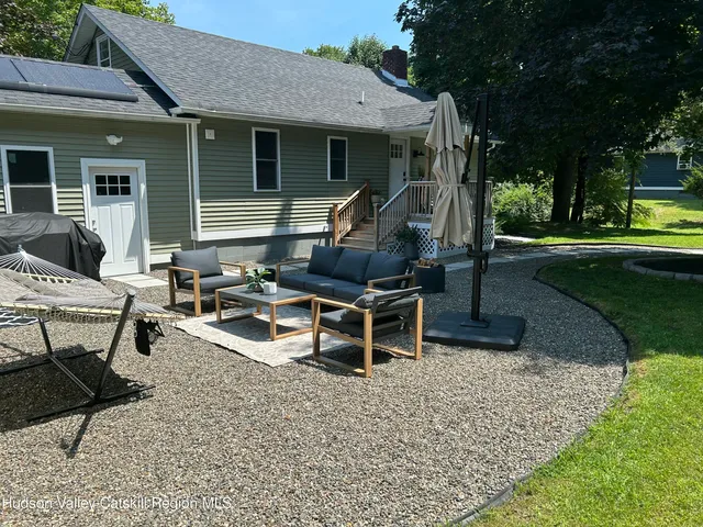 a view of a house with backyard porch and sitting area