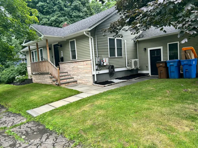 a view of a house with backyard and a tree
