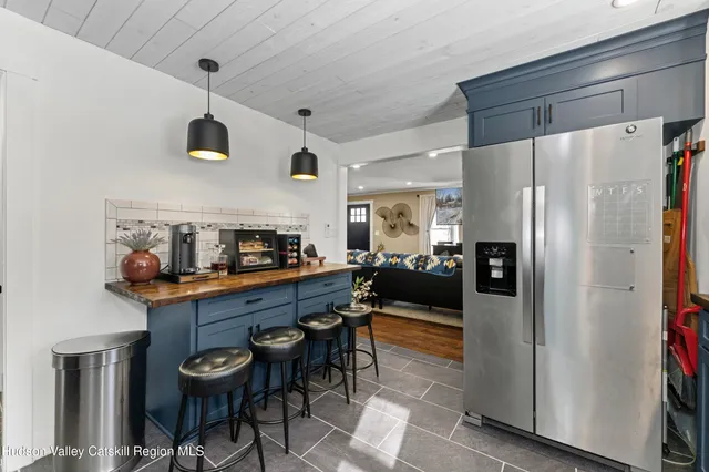 a kitchen with stainless steel appliances a refrigerator and a table
