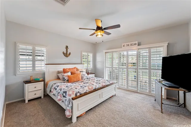 a bedroom with a bed and a flat tv screen on dresser