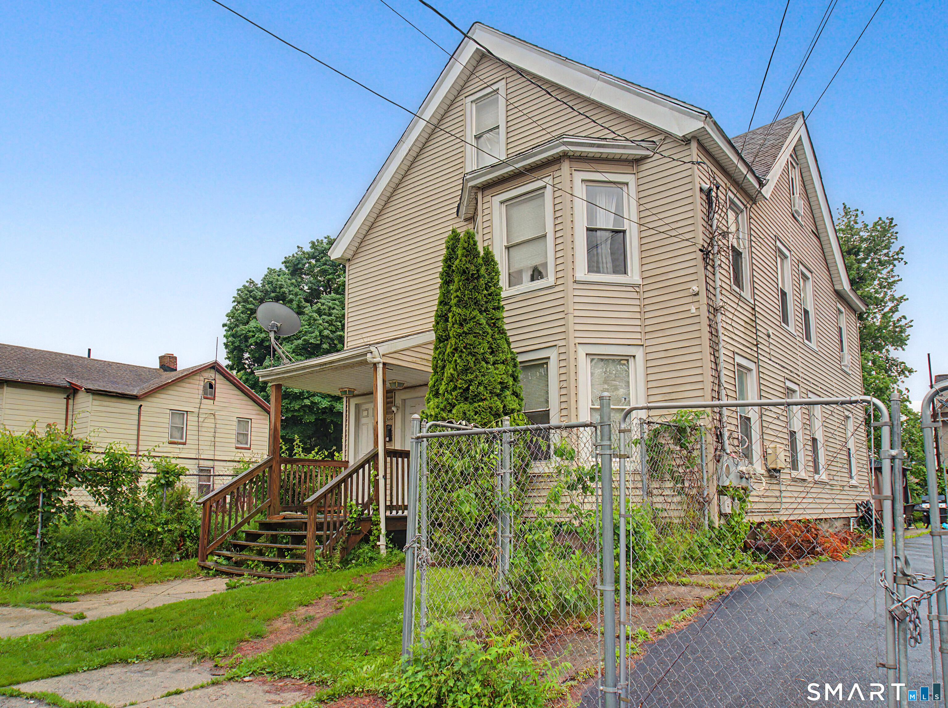 319 Carroll Avenue Bridgeport, CT 06607 - Photo 3 of 40 a view of a house with brick walls and a yard with plants
