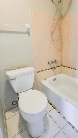 a white toilet sitting next to a bathroom sink