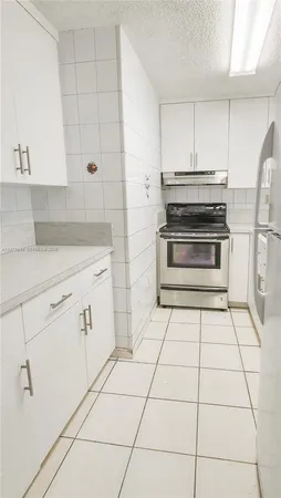a stove top oven sitting inside of a kitchen