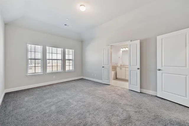 a bathroom with a tub a sink double vanity granite and a mirror