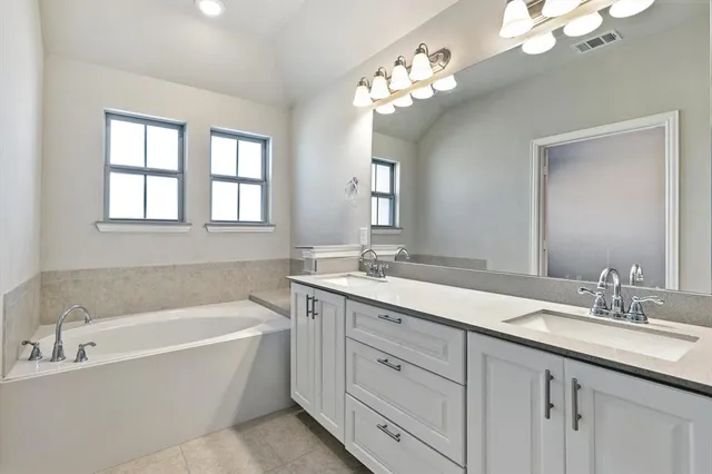 a bathroom with a double vanity sink mirror and double