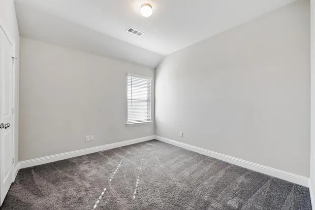 a bathroom with a granite countertop bathtub shower sink mirror vanity and toilet