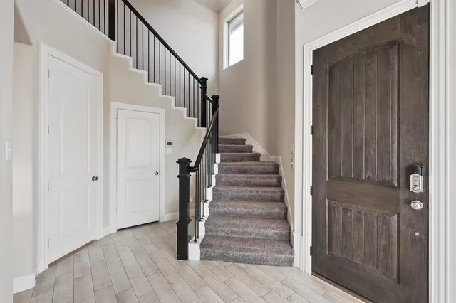 a view of entryway with wooden floor and stairs
