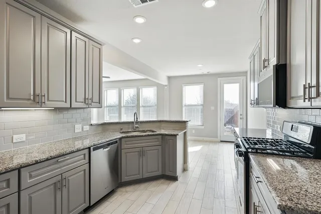 a kitchen with a stove a sink and a refrigerator
