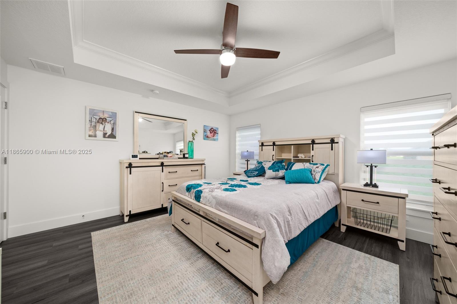 5810 Columbus Boulevard Sebring, FL 33872 - Photo 14 of 49 a bedroom with a bed and a chandelier