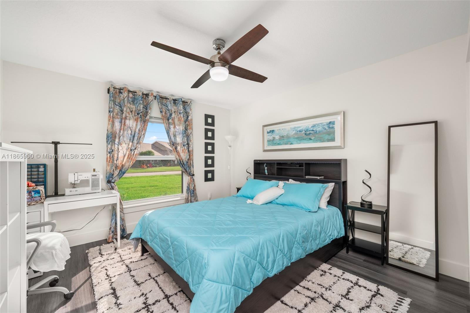 5810 Columbus Boulevard Sebring, FL 33872 - Photo 21 of 49 a bedroom with a bed and a chandelier