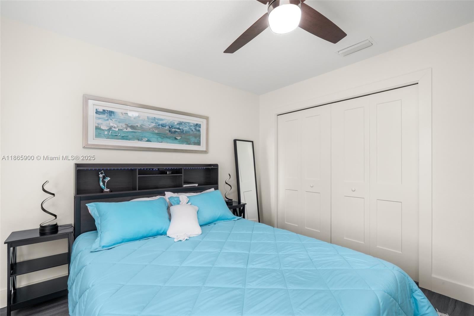 5810 Columbus Boulevard Sebring, FL 33872 - Photo 24 of 49 a bedroom with a large bed and a chandelier