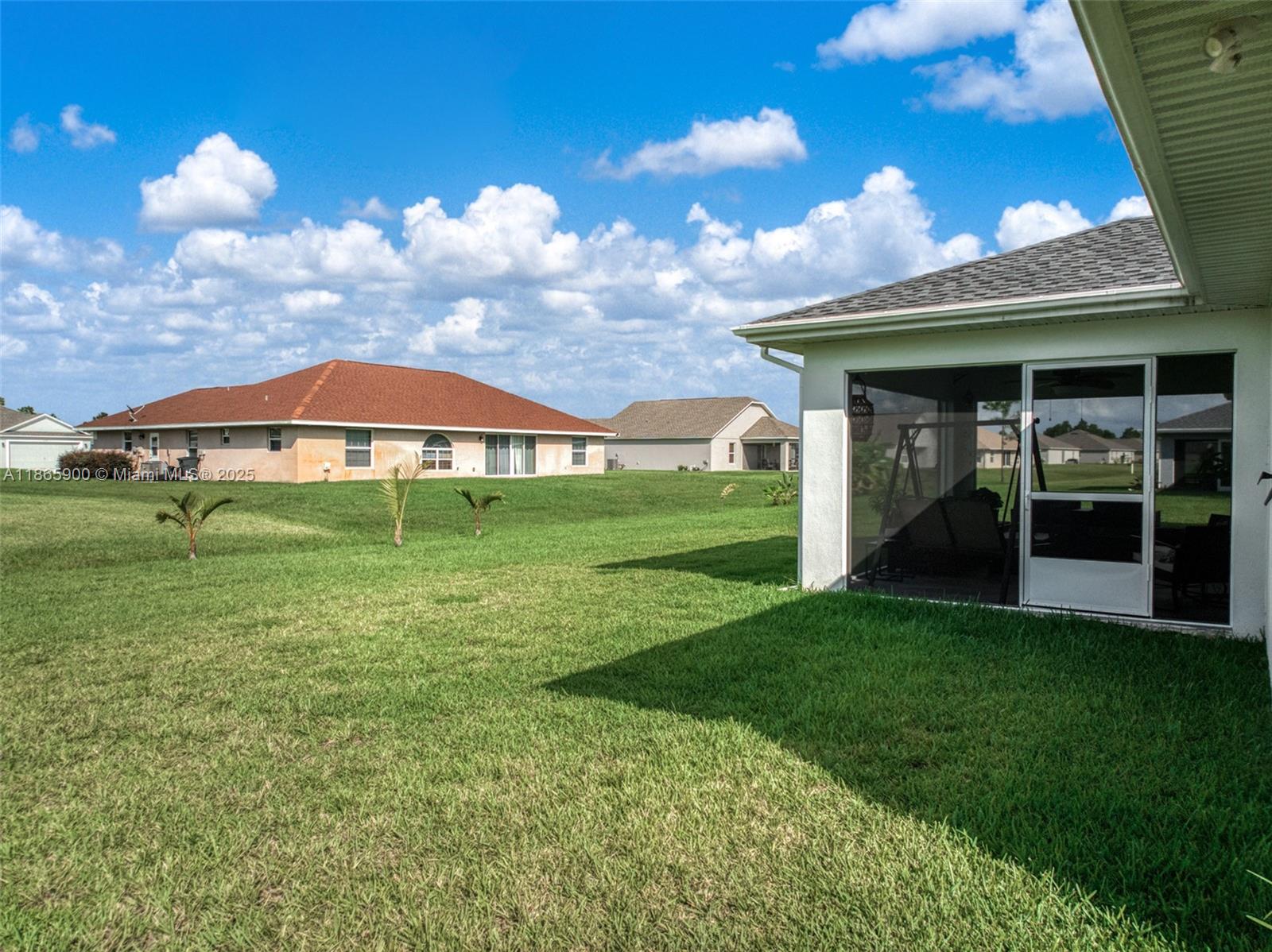 5810 Columbus Boulevard Sebring, FL 33872 - Photo 38 of 49 a view of a bedroom with a big yard and potted plants