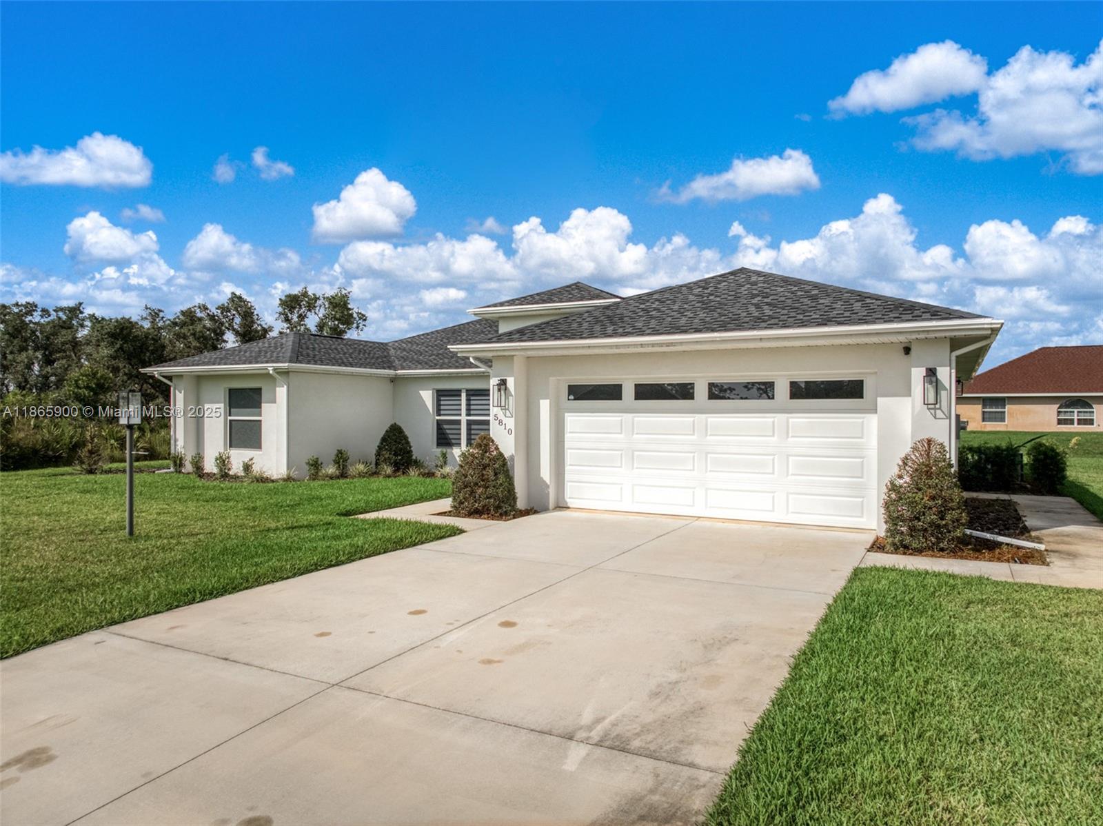 5810 Columbus Boulevard Sebring, FL 33872 - Photo 47 of 49 front view of a house with a yard and potted plants