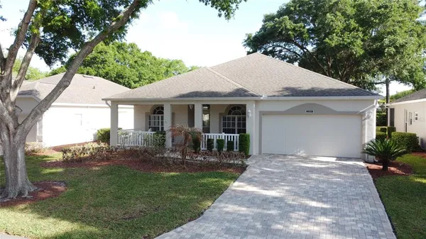 a front view of a house with yard outdoor seating and green space