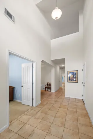 a view of a dining room with furniture and chandelier
