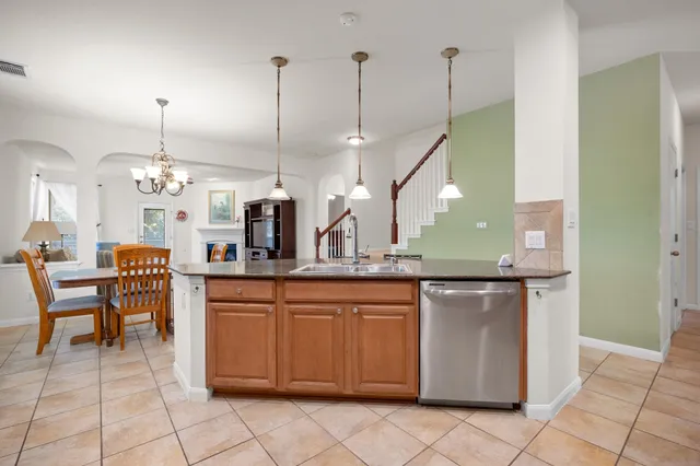 a kitchen with cabinets and a refrigerator