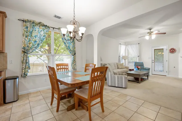 a bedroom with furniture and a chandelier