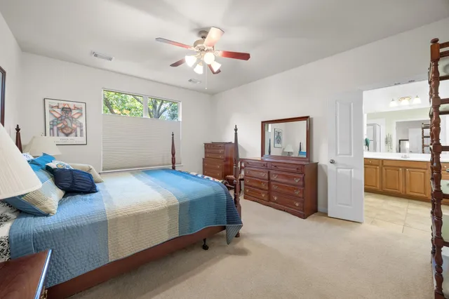 a spacious bathroom with a tub double sink and mirror
