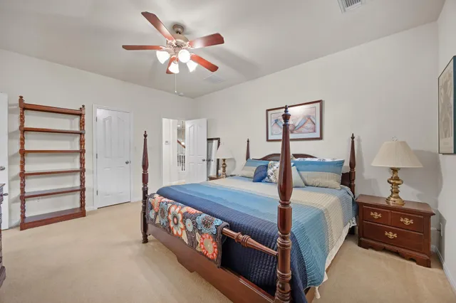 a spacious bathroom with a shower a sink and mirror