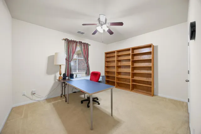 a living room with furniture and a lamp